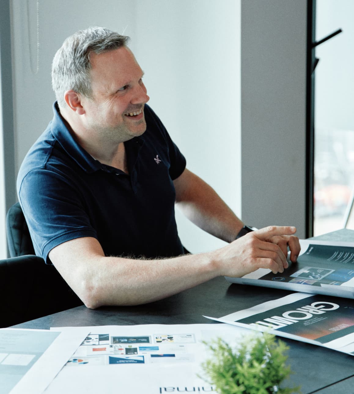 Colleagues engaged in a brainstorming workshop, surrounded by sketches, notes, and laptops.